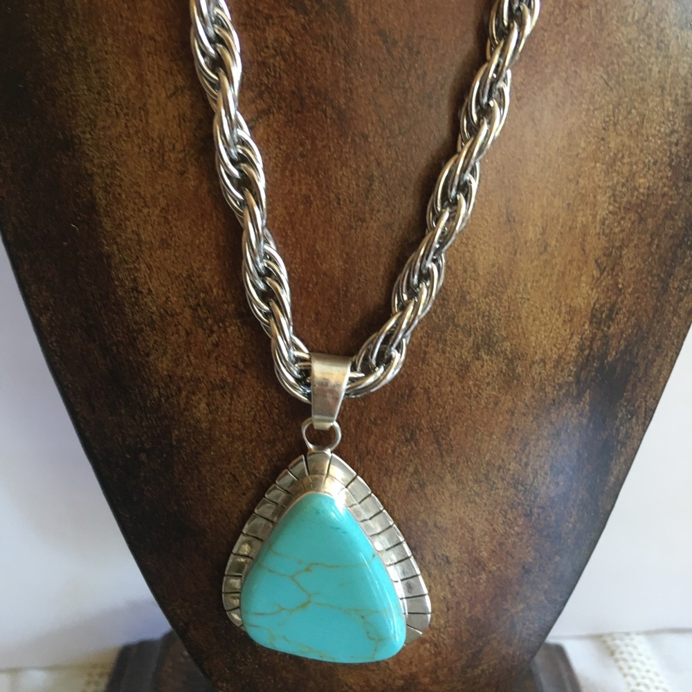 Turquoise colored pendant on silver colored chain